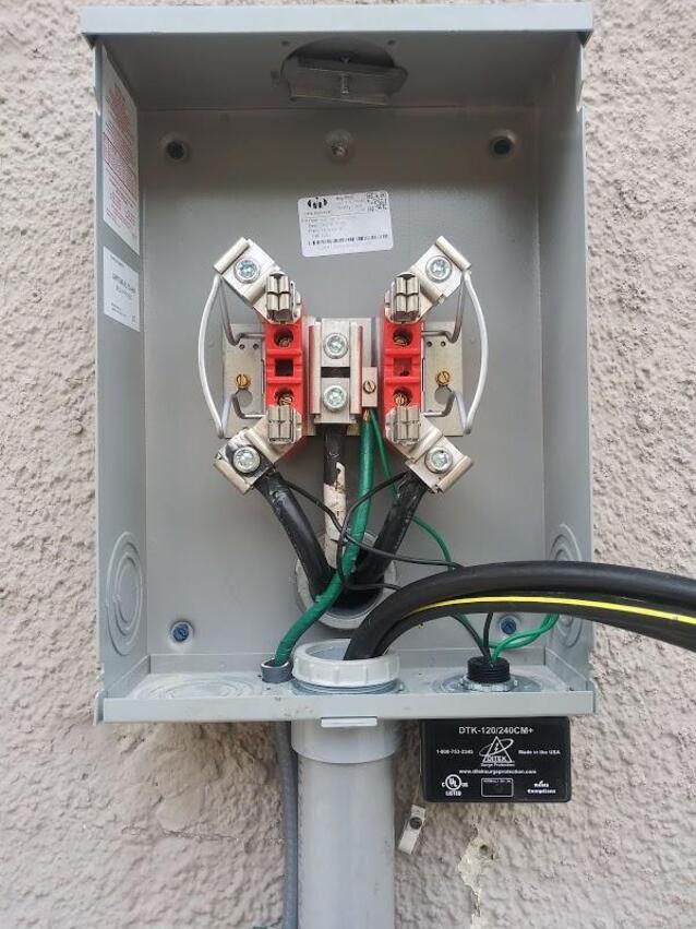 Meter base wiring with surge protector